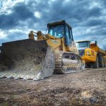 Image of a row of construction trucks